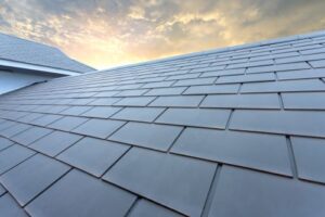 a slate roof on a family home with the sun shining